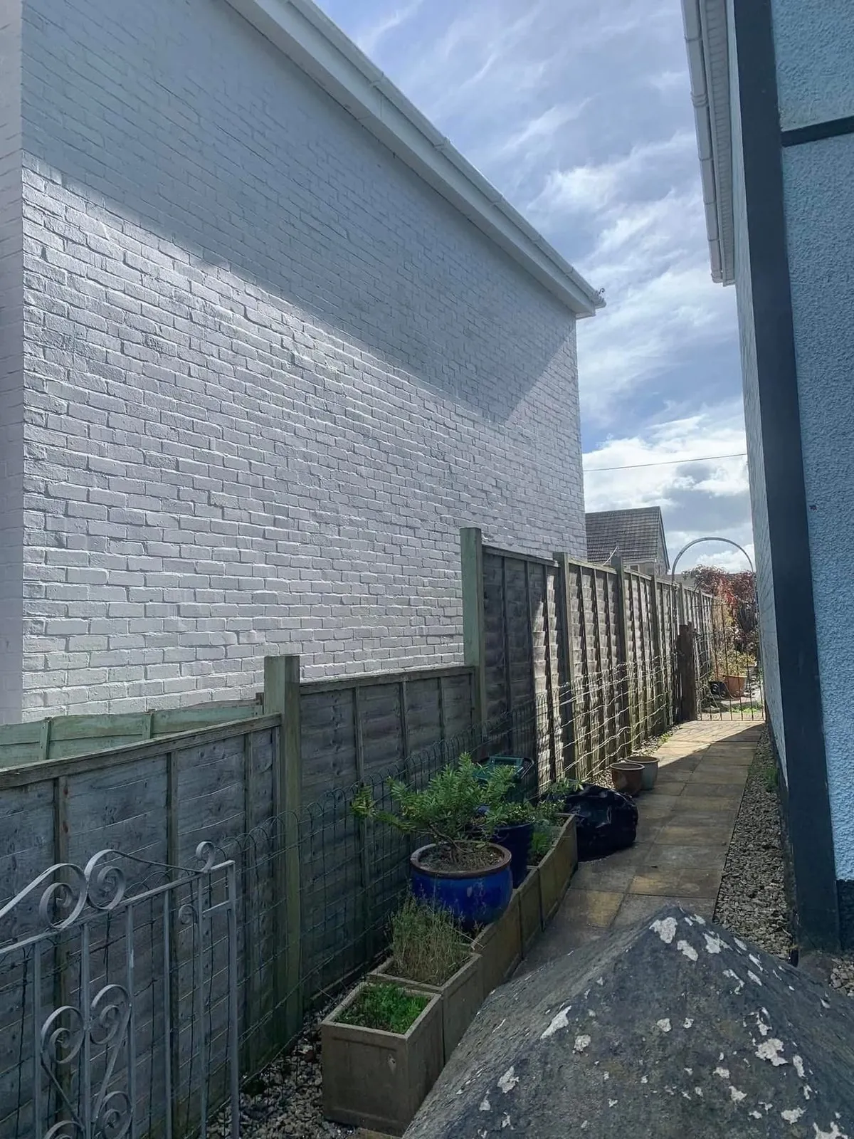 Freshly painted brick wall after preparation and masonry paint in Tavistock